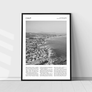 May include: A black and white aerial photograph of Calp, Spain. The image shows the city's coastline, with buildings and a rocky outcropping. The text "CALP" and "ALICANTE, SPAIN 38.5733°N, 0.1154831°E" is visible at the top of the image.