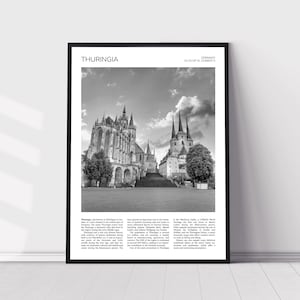 May include: A black and white photograph of a large cathedral in Thuringia, Germany. The cathedral has a tall, pointed roof and many windows. The photo is framed in a black frame with the words "Thuringia" and "Germany" at the top.