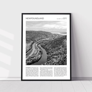 May include: A black and white aerial photograph of a river winding through a forested landscape. The image is framed with a black border and includes the text "NEWFOUNDLAND" and "CANADA 53.1299° N, 57.6004° W".