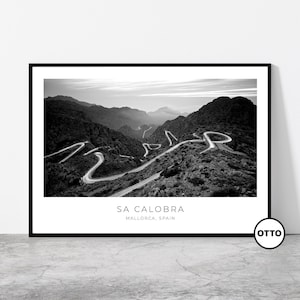 May include: Monochrome framed print depicting a winding road through mountainous terrain. The print includes the text "SA CALOBRA" and "MALLORCA, SPAIN". The image is a landscape photograph.