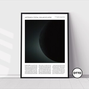 May include: Black framed print featuring a total solar eclipse image. The image shows a dark sphere with a bright crescent, with text at the top reading "Artemis II Total Solar Eclipse". The print includes descriptive text below the image.