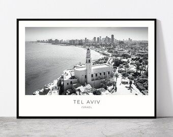 May include: Black and white aerial photograph of Tel Aviv, Israel. The photo shows a cityscape with a church building in the foreground and the Mediterranean Sea in the background.