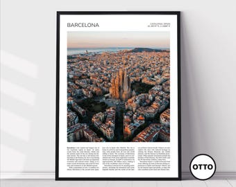 May include: A framed print featuring an aerial view of Barcelona, Spain, with the Sagrada Familia cathedral prominently displayed. The image is set against a sunset sky, with text at the top indicating the city's name and coordinates. The print is in a black frame.
