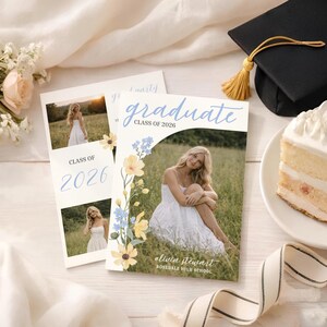 May include: Graduation announcements featuring a photo of a woman in a white dress, with the text "graduate" and "Class of 2026." Floral accents and a graduation cap are also visible. The announcements are on a white surface with a slice of cake.