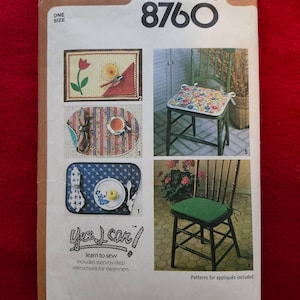 May include: Simplicity sewing pattern number 8760 for a chair cushion and placemats. The pattern includes instructions for beginners and patterns for appliques. The pattern cover shows a floral chair cushion and a placemat with a red flower.
