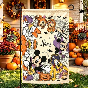 May include: A rectangular garden flag featuring a cream background with a black spiderweb pattern and various cartoon characters in Halloween costumes, including a vampire, a pirate, and a witch, surrounding the centred black text Name.