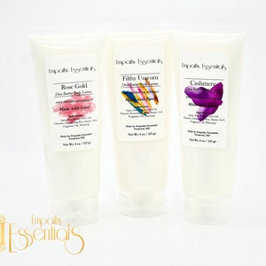 May include: Three white tubes of shea butter body lotion with different scents: Rose Gold, Filthy Unicorn, and Cashmere. Each tube has a colorful design and the text "Made with Love!" on the front.