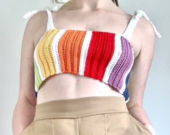 May include: A rainbow striped crochet top with adjustable straps. The top is made of a soft, colourful yarn and has a relaxed fit.