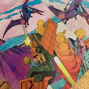 May include: A 100 piece jigsaw puzzle featuring a cartoon illustration of a futuristic vehicle with a purple and green character flying above it. The puzzle is set against a pink, blue, and purple background with clouds and mountains.