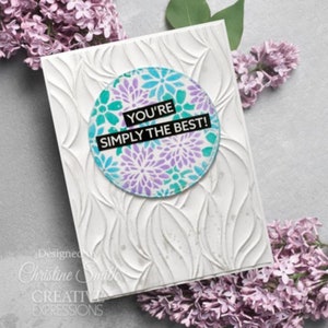 May include: White card with a circle design featuring a purple and teal floral pattern. The text "You're Simply the Best!" is printed in black on a white banner.