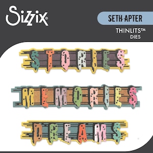 May include: Sizzix Thinlits dies displaying the words "STORIES", "MEMORIES", and "DREAMS". Each word is in a different colour, set against a wood-effect background. The words are in a playful, stylised font.