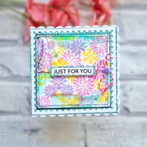 May include: A white card with a scalloped edge and a teal border. The card has a colorful floral pattern and the words "JUST FOR YOU" in black text.