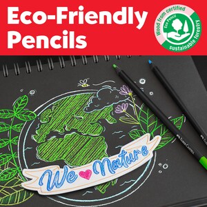 May include: Two black Faber-Castell pencils resting on a black sketchbook page featuring a green and white drawing of the Earth, flowers, and a bee. A white banner across the center displays the blue text We Love Nature with a pink heart icon.