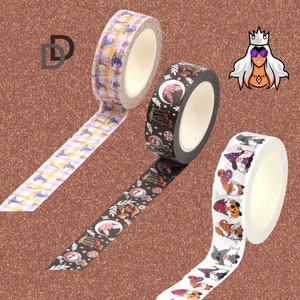 May include: Three rolls of decorative washi tape with Halloween themes. One roll features a purple and white plaid pattern with witches' hats, another has a black background with a white witch, mushrooms, and stars, and the last roll has a white background with colorful gnomes wearing witch hats.