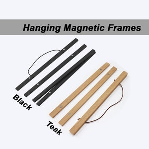 May include: Two hanging magnetic frames, one black and one teak wood. Both frames have a string attached for hanging.
