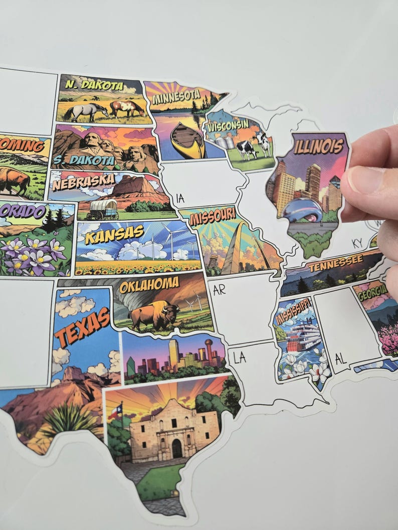 Op de afbeelding: Een kaart van de Verenigde Staten met kleurrijke staatsillustraties. De kaart toont staatsnamen en iconische afbeeldingen, waaronder bezienswaardigheden en dieren in het wild. Een Illinois-sticker wordt omhoog gehouden, klaar om op de kaart te worden geplakt.
