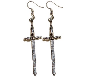 May include: A pair of silver sword-shaped earrings with a textured design.