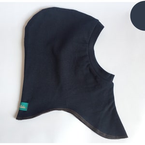 May include: A dark blue balaclava with a brown trim. The balaclava has a label that says "Little State".