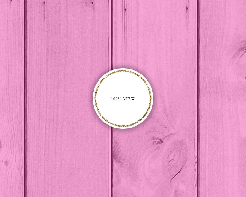 May include: A white circle with a gold glitter border on a pink wood background. The circle contains the text "100% VIEW".
