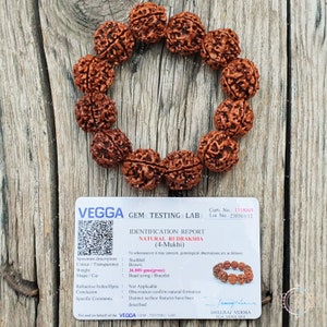 May include: A close-up of a brown Rudraksha bead bracelet with 4 faces. The bracelet is on a wooden surface. The image includes a certificate of authenticity from VEGGA GEM TESTING LABS. The certificate states that the bracelet is made of natural Rudraksha and weighs 36.000 grams.