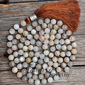 A handmade gray moonstone mala necklace with 108 beads, designed for perception and meditation. This gemstone necklace combines spiritual significance with elegant design, perfect for enhancing focus during meditation or as a meaningful accessory