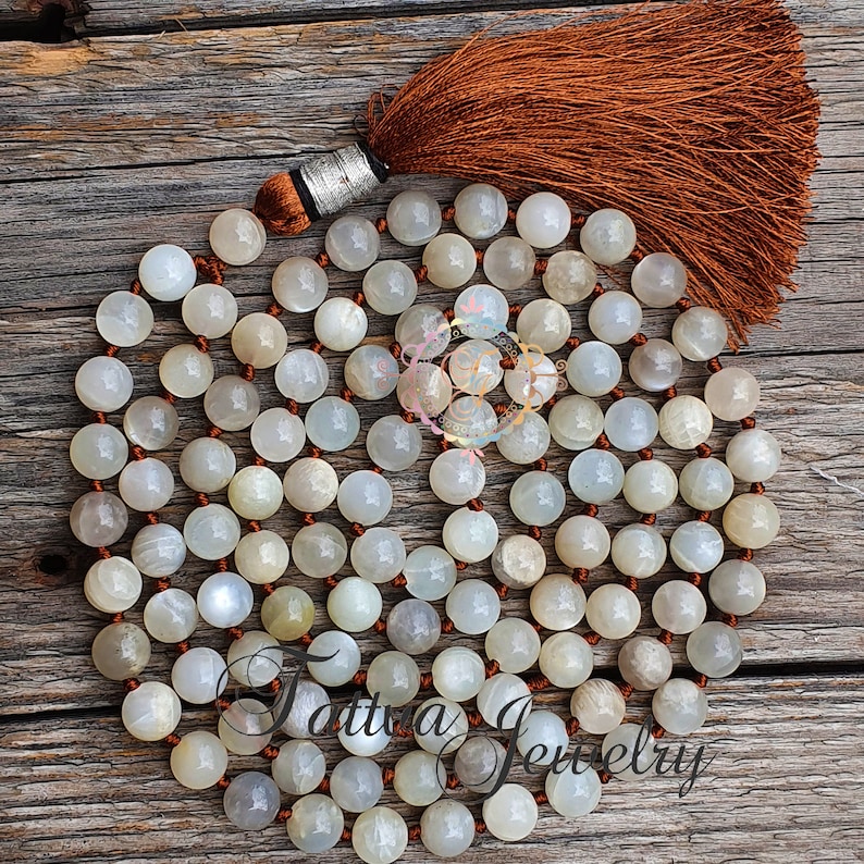 A handmade gray moonstone mala necklace with 108 beads, designed for perception and meditation. This gemstone necklace combines spiritual significance with elegant design, perfect for enhancing focus during meditation or as a meaningful accessory