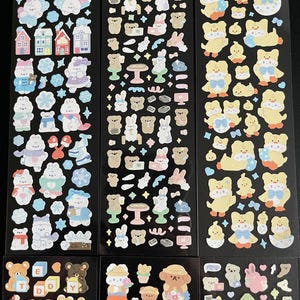 May include: Six sheets of stickers featuring various cute animal designs. The stickers include bears, bunnies, and chicks. The stickers are on a black background and are perfect for adding a touch of whimsy to your planner, journal, or other craft projects.