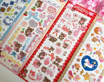 May include: Four sheets of colorful stickers featuring cute cartoon bears, stars, and other whimsical designs. The stickers are perfect for decorating journals, planners, and other craft projects.