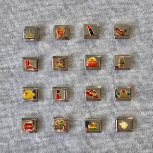 May include: A collection of 16 silver charm bracelets with various colourful enamel charms, including a crown, lipstick, boot, purse, hat, nail polish, and a mask.