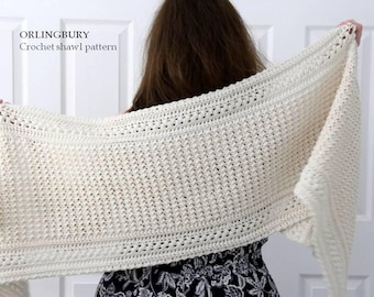 May include: An off-white crochet shawl featuring a textured stitch pattern with horizontal borders. The text "ORLINGBURY Crochet shawl pattern" is printed in the upper left corner of the image.