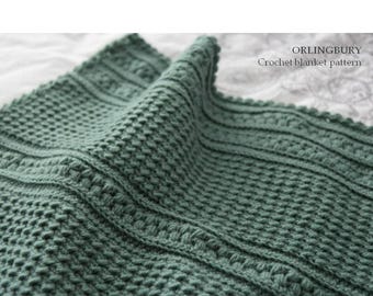 May include: A sage green crochet blanket featuring a textured stitch pattern with alternating rows of raised vertical lines and small bumps. The text ORLINGBURY Crochet blanket pattern is printed in the upper right corner of the image.