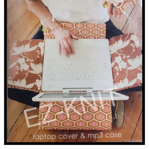 May include: A sewing pattern for a laptop cover and MP3 case from Amy Butler's Midwest Modern line. The pattern features a geometric design in shades of pink, orange, and brown.