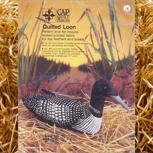 May include: A pattern and kit for quilting a loon. The kit includes screen-printed fabric for the loon's top feathers and breast. The finished size is 17 inches by 8 inches. No. 407 Loon Pattern includes: screen-printed fabric for top feathers and breast. No. 406 Loon Kit includes: Pattern, instructions, and all materials for completion of Quilted Loon. (Fiberfill not included)