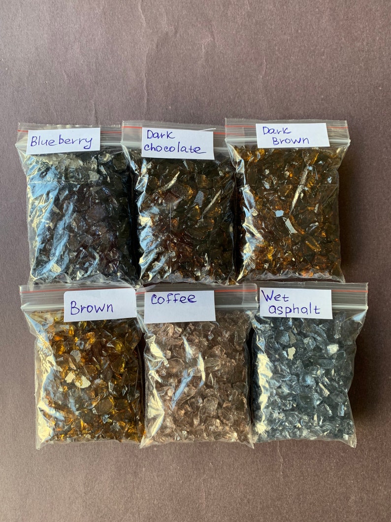 May include: Six small bags of crushed glass, each labeled with a color name: Blueberry, Dark Chocolate, Dark Brown, Brown, Coffee, and Wet Asphalt.