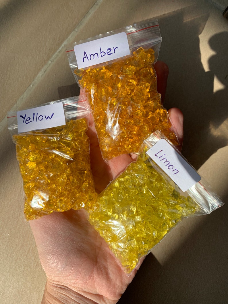 May include: Three small bags of glass beads in different shades of yellow. The bags are labelled "Amber", "Yellow", and "Limon".