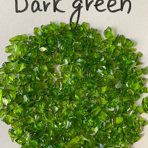 May include: Dark green glass pieces, also known as crushed glass or glass chips, are a popular material for crafts and home decor projects.