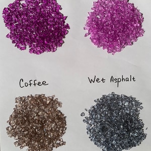 May include: Four piles of small, clear glass pieces in different colors: violet, lavender, coffee, and wet asphalt.
