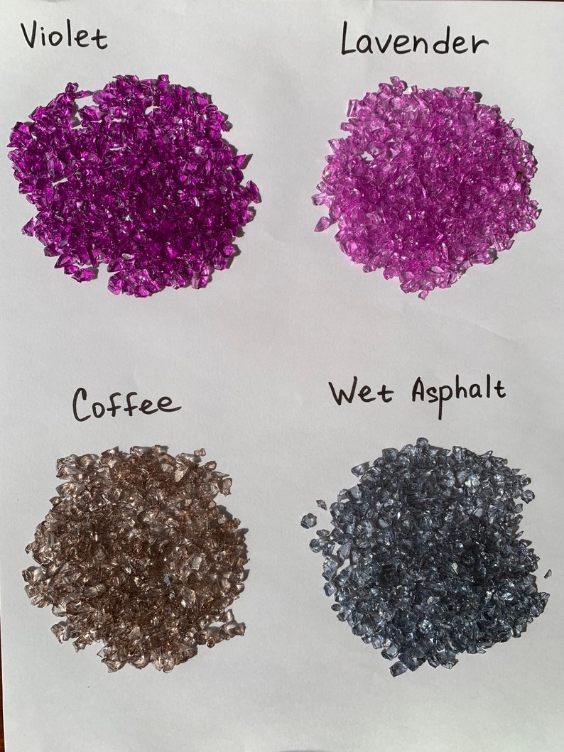 May include: Four piles of small, clear glass pieces in different colors: violet, lavender, coffee, and wet asphalt.