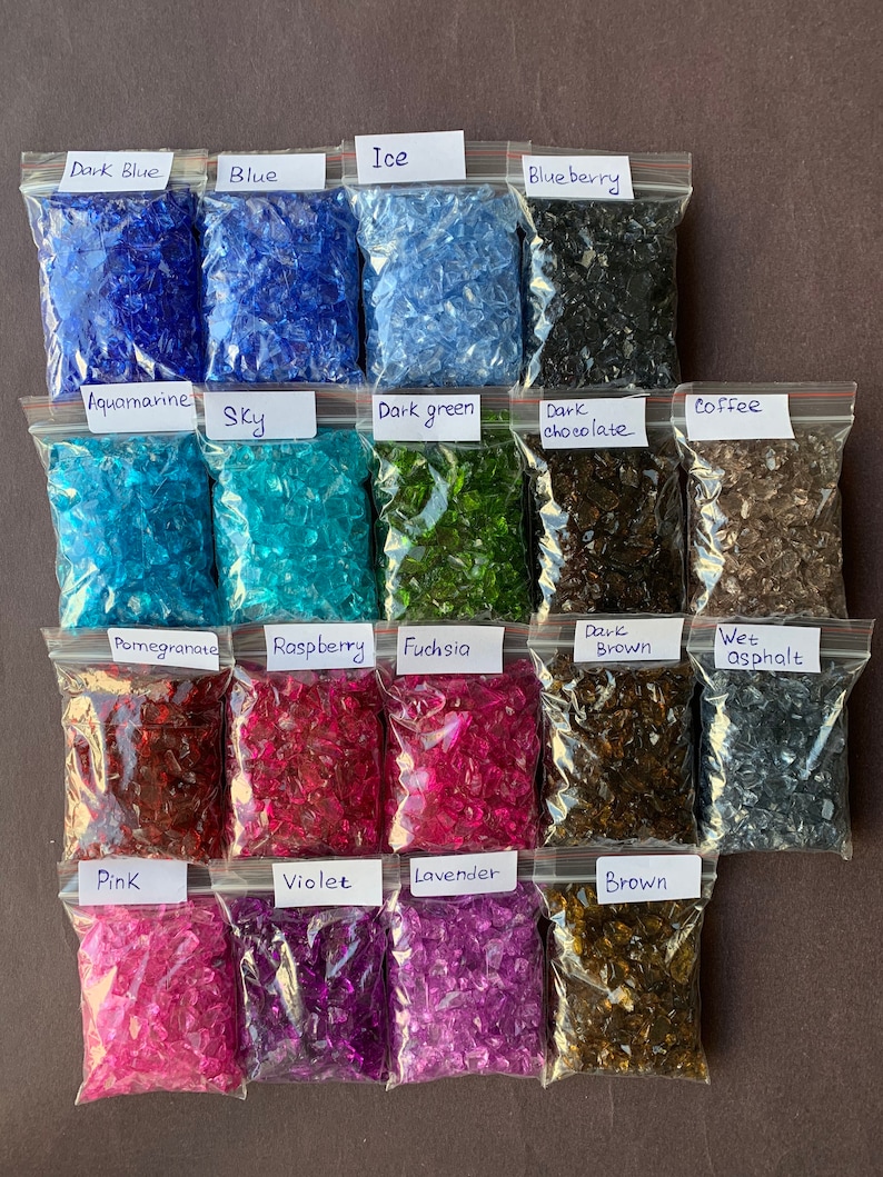 May include: Assortment of small glass pieces in various colors, packaged in clear plastic bags. The bags are labeled with the color names, including "Dark Blue", "Blue", "Ice", "Blueberry", "Aquamarine", "Sky", "Dark Green", "Dark Chocolate", "Coffee", "Pomegranate", "Raspberry", "Fuchsia", "Dark Brown", "Wet Asphalt", "Pink", "Violet", "Lavender", and "Brown".