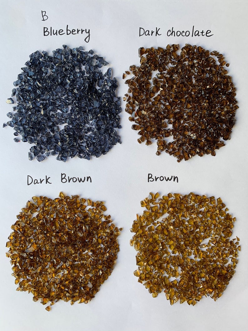 May include: Four piles of crushed glass in different colors: blueberry, dark chocolate, dark brown, and brown.