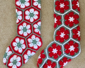 May include: Two crocheted Christmas stockings in red, white, and green with a flower pattern.