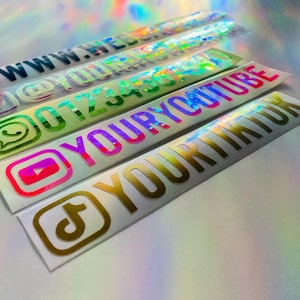 May include: A set of five rectangular holographic stickers featuring social media icons and text. The stickers display the text WWW.WEBSITE, @YOURHANDLE, 0123456789, YOURYOUTUBE, and YOURTIKTOK, accompanied by corresponding globe, Instagram, WhatsApp, YouTube, and TikTok icons.
