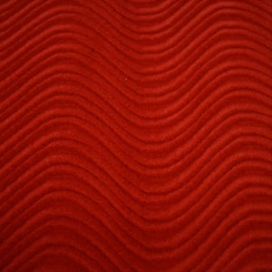 May include: Red fabric with a wavy, textured pattern.