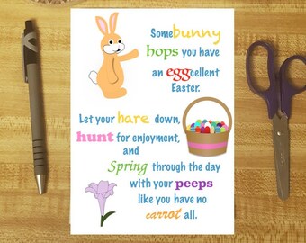 May include: An assortment of stationery items including a pen, scissors, glue stick, and a decorative inkwell with a feather. A white card features a cartoon bunny and Easter-themed text.