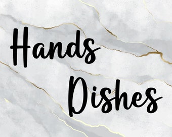 May include: A rectangular sign featuring a white and light gray marble background with thin gold veining throughout. The text Hands Dishes is printed in a bold, black, cursive script font centered across the marble surface of the sign.