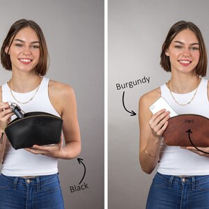 May include: Two women are holding open a black leather cosmetic bag and a burgundy leather cosmetic bag. The black bag has the word "Black" written below it. The burgundy bag has the word "Burgundy" written above it and the word "Design 1" written below it. The burgundy bag has the initials "JMC" embossed on the front.