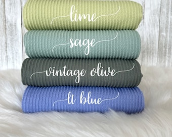 May include: Stack of five ribbed fabric swatches in different colors: lime green, sage green, vintage olive, light blue, and white. The swatches are labeled with their color names.