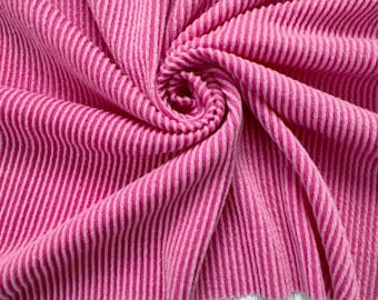 May include: Pink and white striped fabric with a soft, textured feel. The fabric is folded and arranged in a spiral pattern.