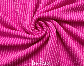 May include: Fuchsia pink and white striped textured fabric. The fabric is soft and stretchy, making it perfect for a variety of projects.