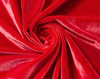 May include: A close-up of a vibrant red velvet fabric, artfully arranged in a swirling pattern. The plush material reflects light, highlighting its soft texture and rich color. This luxurious fabric is ideal for apparel and home decor projects.